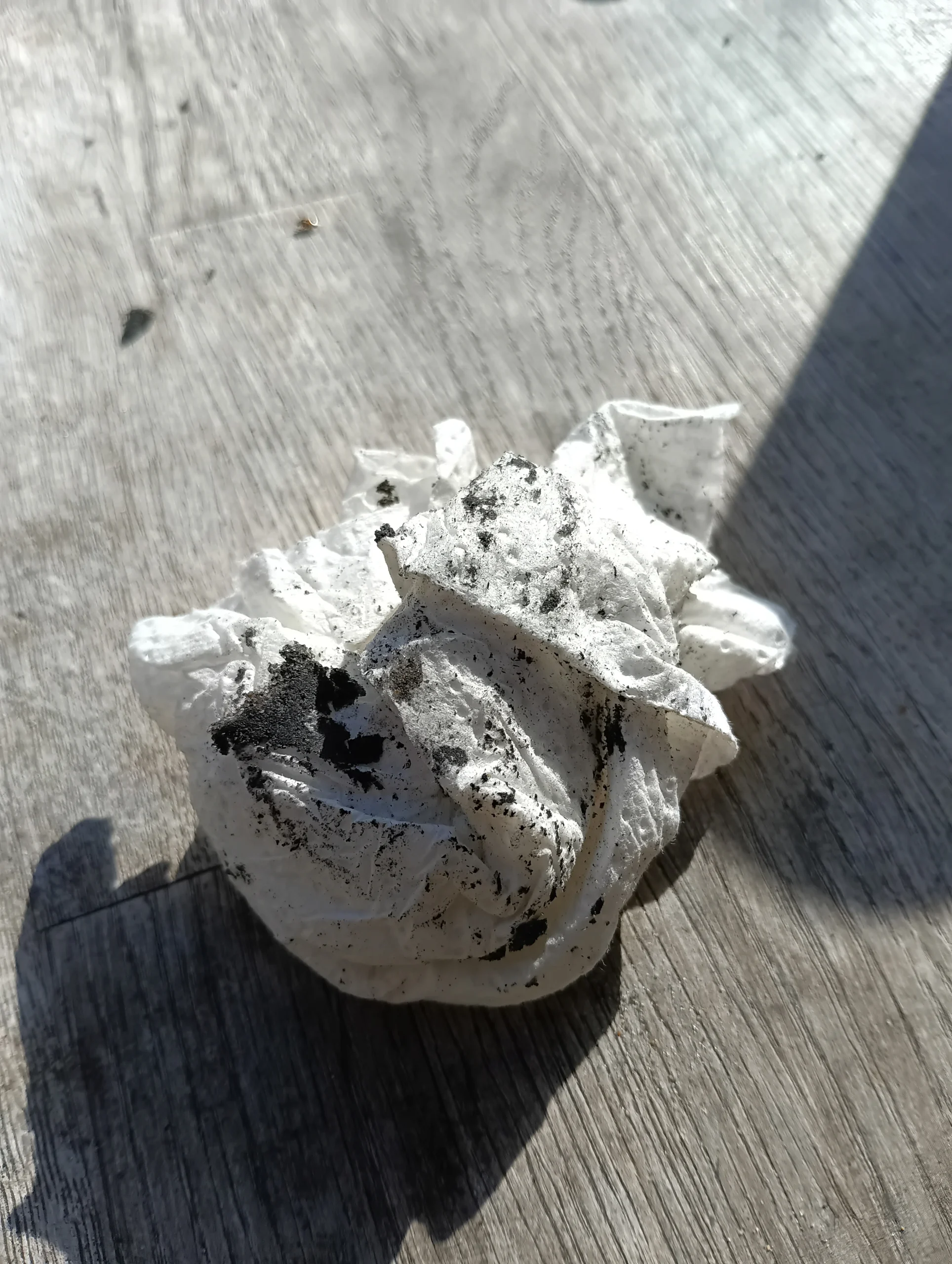 Photo of a cleaning paper filled with fill during the cleaning procedure of the inside components of a Mystic Kite Pump Extreme during Kite Pump Maintenance and Kite Pump Repair